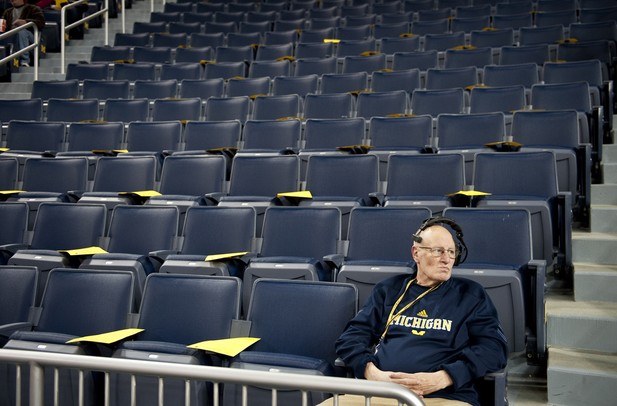 Audio tech Tim Ofarrelo sits in an empty seating section before the game between Michigan and Binghamton on Tuesday. Daniel Brenner I AnnArbor.com